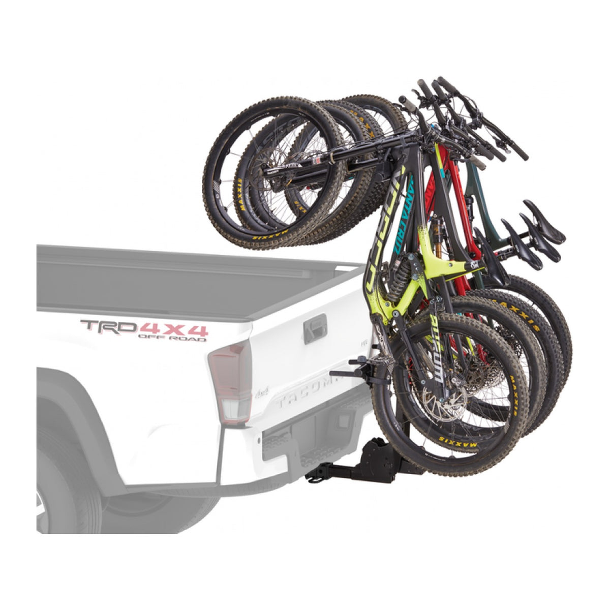 Four mountain bikes hanging behind a white ute